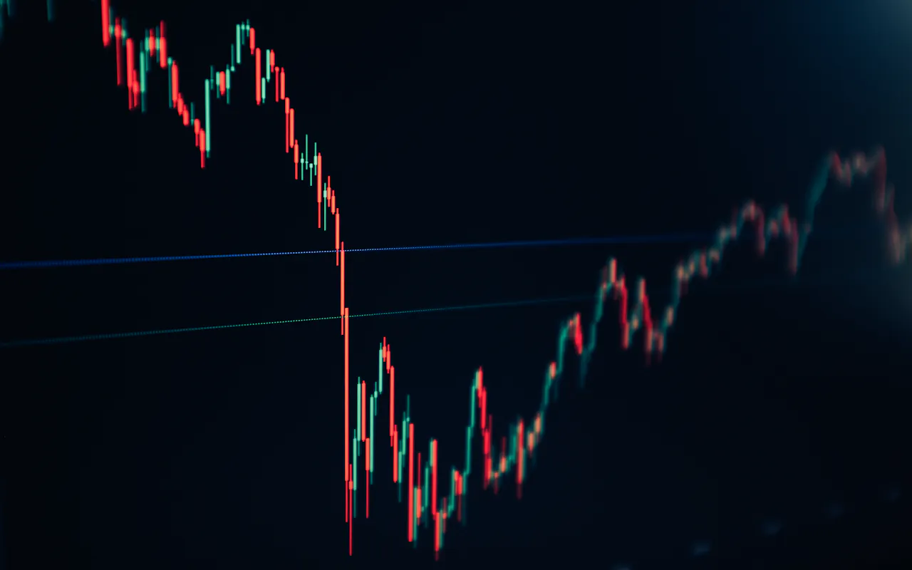 Candlestick market chart on a dark screen